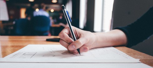 hand-writing-paper-with-pen